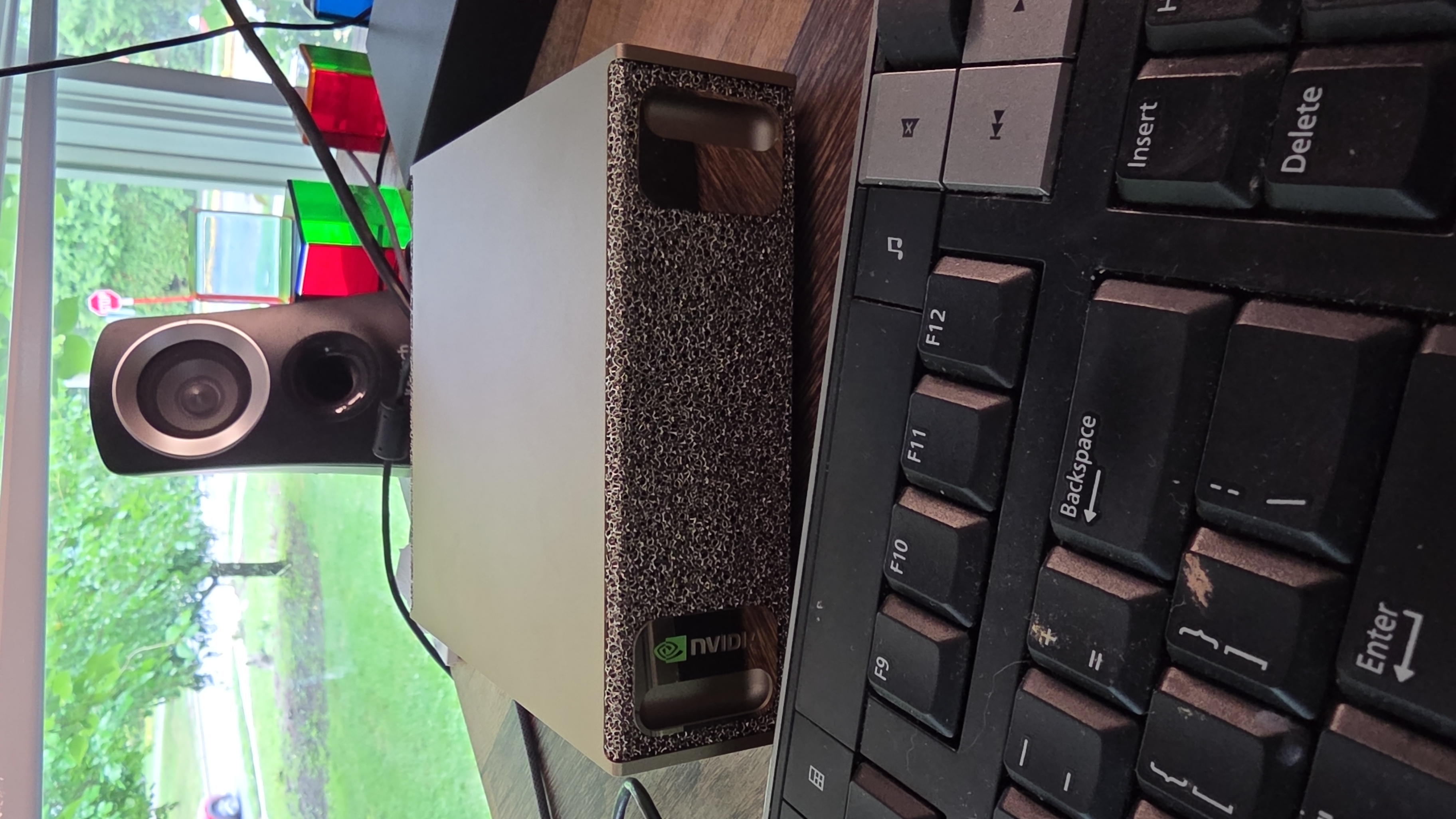The DGX Spark unit sitting on the desk, gold finish catching the light